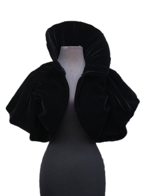 A cute short bolero jacket made out of black velour fabric. Add this bolero to any outfit for some extra style!  Bolero is one size, drapes over the shoulders, has a long thick collar, and stretchy armholes to fit any body type! 