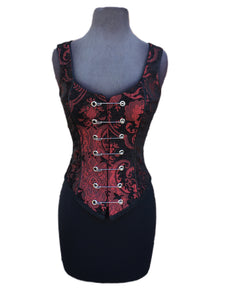 A Shrine classic!! A heavily constructed corset top in rich red and black tapestry fabric with a great form fit. Heavy metal boning at sides and lycra stretch panel at back adds extra strong support. Fastens in front with seven large kilt pins but also zips in back for easy access. Rich black satin piping around armholes and neckline and black satin lining inside. Trimmed at the bottom with black braid. This is one of our favorites! A very flattering fit!  