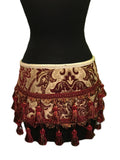 A burlesque and belly dance classic! An extravagant tapestry kilt (or extra wide belt). This beautiful skirt can be worn over pants, hot pants or even another skirt. Made in rich burgundy and ivory tapestry fabric with sleek ivory satin lining on the inside. Wide braided trim at the waistband neatly edged in ivory satin piping. Two rows of regal tassel upholstery trim run along the bottom. Fastens in front with two large metal D-rings and clasps. 